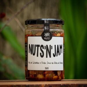 Pote de vidro da geleia de pimenta com castanhas Nuts'n Jam Rutz 350g sobre tábua rústica de madeira.