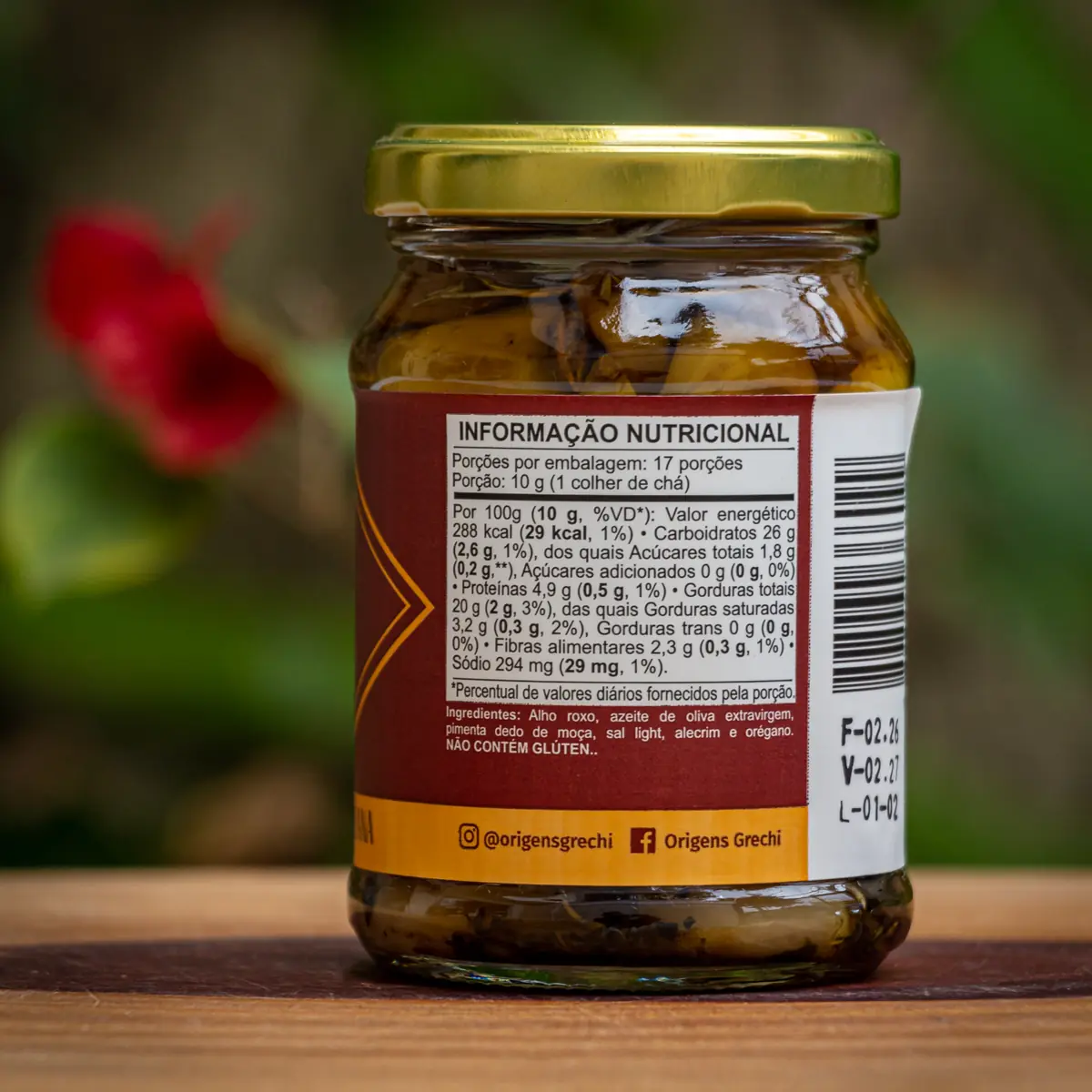 Tabela nutricional e ingredientes do Alho Confit Origens Grechi, indicando uso de alho roxo e sal light.